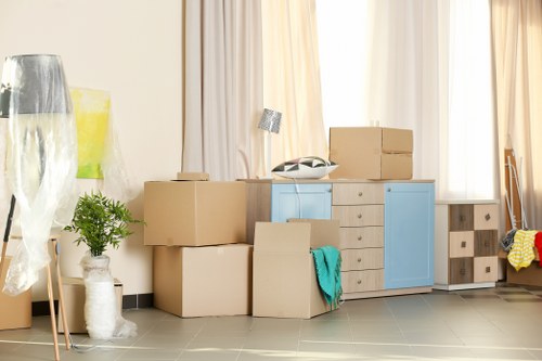 Removal team planning a flat move in Merton with boxes and furniture