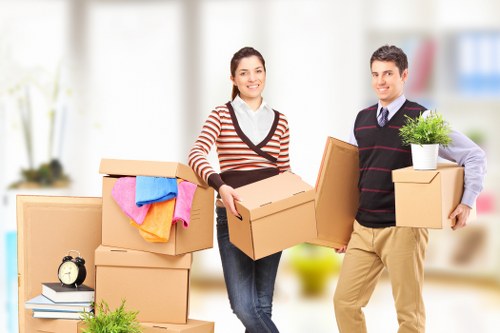 Removals team handling boxes and furniture on moving day